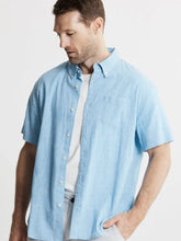 Load image into Gallery viewer, Man wearing a light blue short-sleeve shirt on a plain background