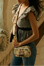 Load image into Gallery viewer, Woman holding a patterned bag in an ornate architectural setting