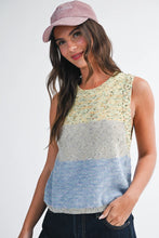 Load image into Gallery viewer, Woman wearing a sleeveless, multicolored knit top with a plain background
