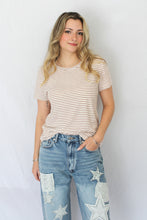 Load image into Gallery viewer, Woman wearing a striped t-shirt and jeans against a plain background
