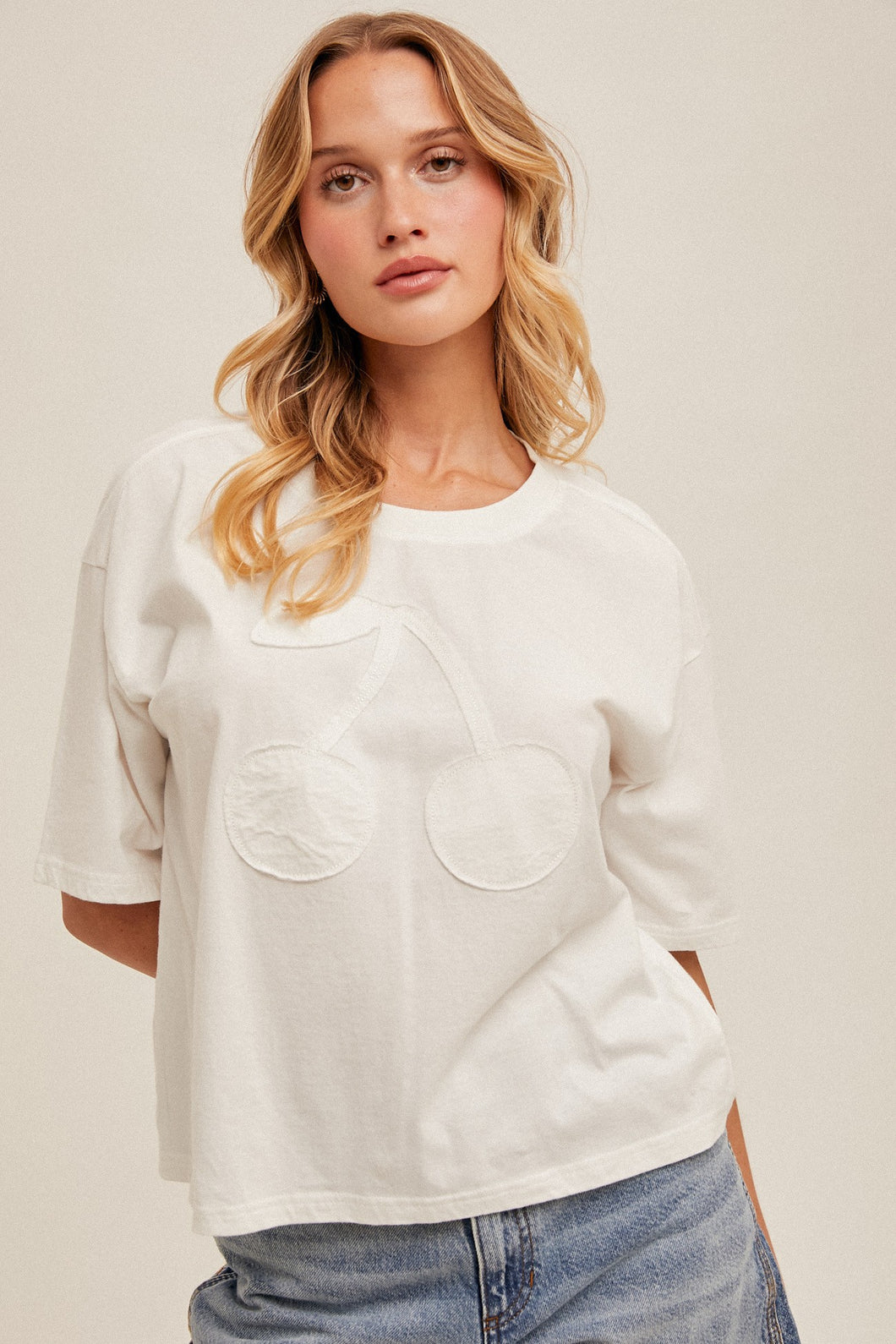 white tee with cherry patch detail
