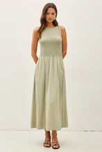 Load image into Gallery viewer, Woman wearing a light green sleeveless dress against a white background
