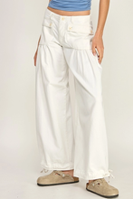 Load image into Gallery viewer, Person wearing white wide-leg pants with a plain background
