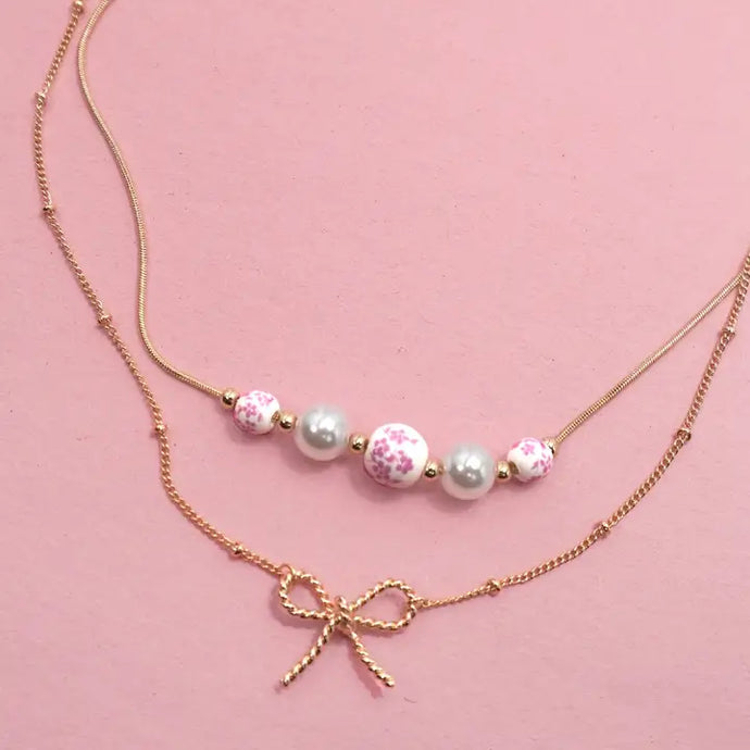 double layer necklace with bow charm, ceramic beads and pearls