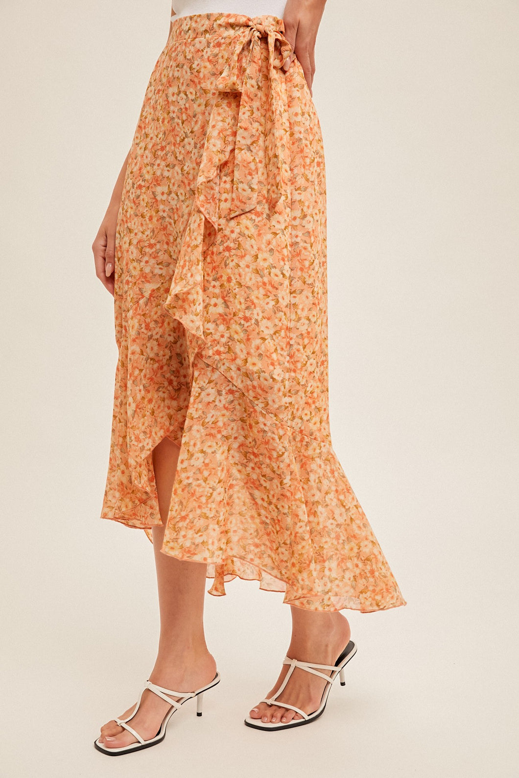 Wrap style floral midi skirt with asymmetrical hem line