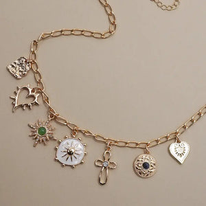 Necklace with cross, heart and sunburst charms