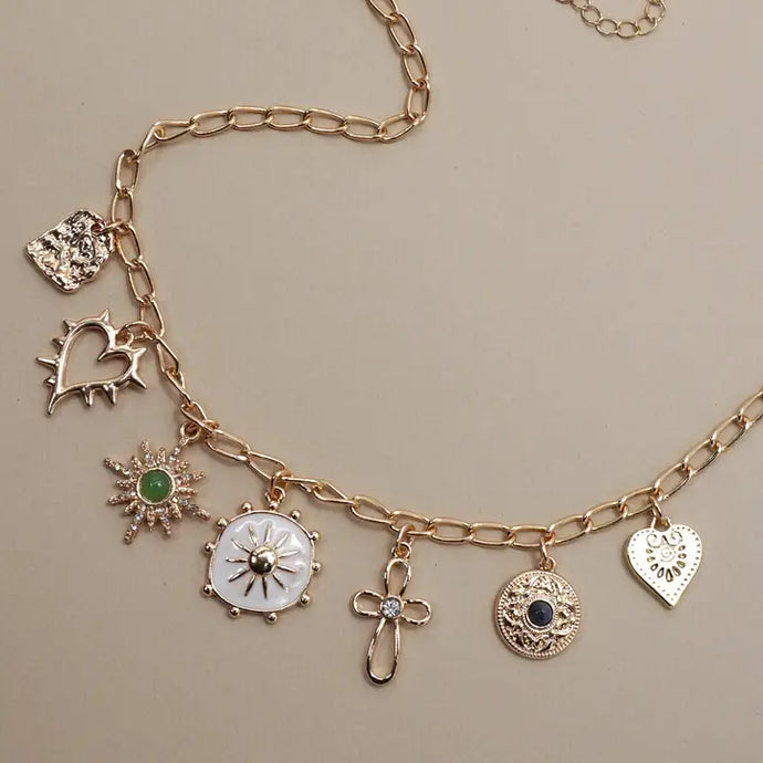 Necklace with cross, heart and sunburst charms