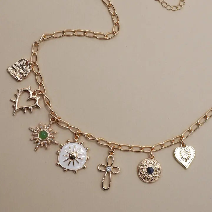 Necklace with cross, heart and sunburst charms